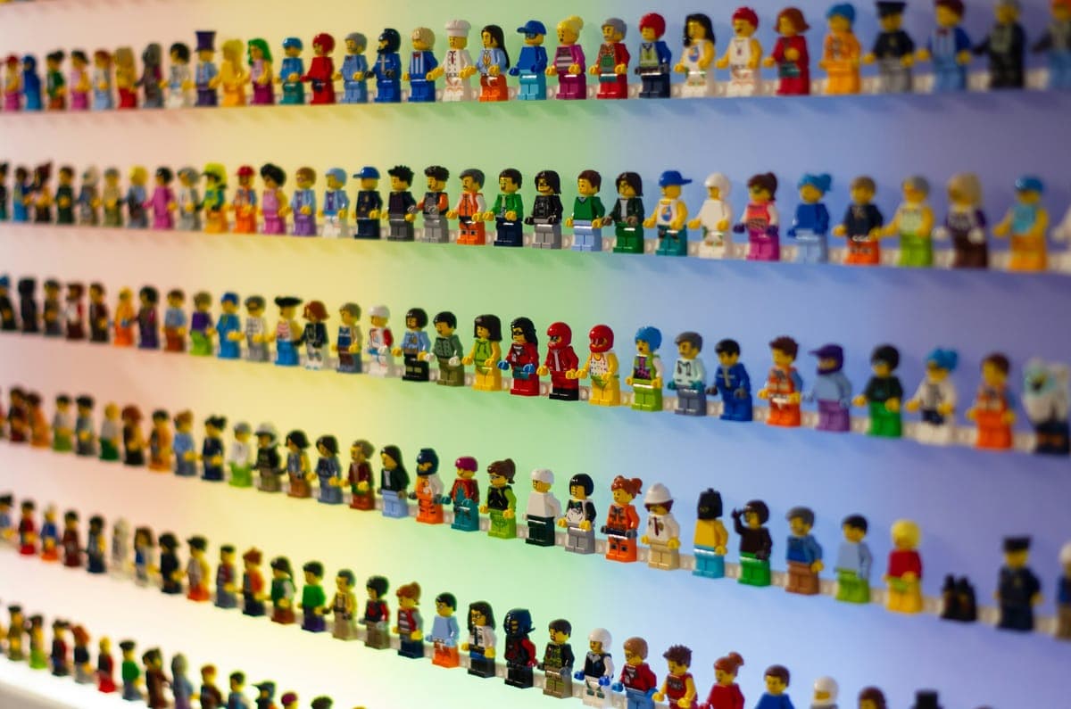 Rows of LEGO minifigures on display wall